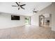 A spacious living room features tile flooring, neutral paint, high ceilings, and natural light from the sliding door at 1723 E Behrend Dr, Phoenix, AZ 85024