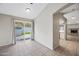 Bright living area with tile flooring, a sliding door to the backyard, and a view of a fireplace at 1723 E Behrend Dr, Phoenix, AZ 85024