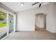 A light filled living room with tile floors, and an archway leading to the kitchen and other rooms at 1723 E Behrend Dr, Phoenix, AZ 85024