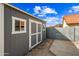 Backyard shed with double doors and windows, offering practical storage space and potential for various uses at 1723 E Behrend Dr, Phoenix, AZ 85024