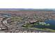 Community aerial view showcasing clubhouse, pool area, lake, and residential homes at 17878 W Amber Ridge Way, Goodyear, AZ 85338