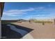 A landscape path leads through gravel yard to a patio with outdoor seating at 17878 W Amber Ridge Way, Goodyear, AZ 85338