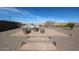 Outdoor seating area on a brick patio features a comfortable woven sofa and a small table at 17878 W Amber Ridge Way, Goodyear, AZ 85338