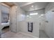 Elegant bathroom showcasing a glass-enclosed shower with a towel rack and access to the bedroom at 17878 W Amber Ridge Way, Goodyear, AZ 85338