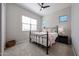 Cozy bedroom featuring neutral walls, carpet, a metal bed frame, and a ceiling fan at 17878 W Amber Ridge Way, Goodyear, AZ 85338