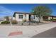 Street view showing a charming single-story home with desert landscaping and a brick driveway at 17878 W Amber Ridge Way, Goodyear, AZ 85338