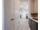 Hallway featuring gray cabinets and light colored floors at 17878 W Amber Ridge Way, Goodyear, AZ 85338