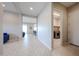 Hallway with tile flooring leading to the laundry room and various living spaces at 17878 W Amber Ridge Way, Goodyear, AZ 85338