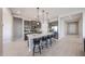 Modern kitchen featuring gray cabinets, a central island with bar stool seating, and sleek stainless steel appliances at 17878 W Amber Ridge Way, Goodyear, AZ 85338