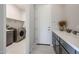 Laundry room with washer, dryer, utility sink, storage, and counter space at 17878 W Amber Ridge Way, Goodyear, AZ 85338