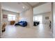 Open living room with tile flooring and stylish furnishings, bathed in natural light from the window at 17878 W Amber Ridge Way, Goodyear, AZ 85338