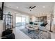 Open living space with tile flooring that flows into the kitchen, adjacent to a cozy seating area at 17878 W Amber Ridge Way, Goodyear, AZ 85338