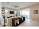 Bright living room with tile floors, large sliding doors, and stylish decor on a console table at 17878 W Amber Ridge Way, Goodyear, AZ 85338