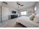 Comfortable main bedroom featuring a ceiling fan, neutral decor, and soft carpet at 17878 W Amber Ridge Way, Goodyear, AZ 85338