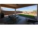 Inviting outdoor living area featuring artificial turf, comfortable seating, and desert views at 17878 W Amber Ridge Way, Goodyear, AZ 85338