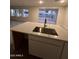 Large kitchen island with stainless steel sink and modern faucet at 18243 W Larkspur Dr, Goodyear, AZ 85338