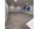 Open concept living room with wood-style tile floors and neutral colored walls at 18243 W Larkspur Dr, Goodyear, AZ 85338