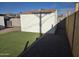 Backyard featuring a storage shed, small artificial grass lawn, gravel, and a fence at 1835 E Atlanta Ave, Phoenix, AZ 85040