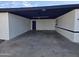 Spacious covered carport featuring painted brick walls and black trim, offering ample parking and protection at 1835 E Atlanta Ave, Phoenix, AZ 85040