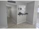 View of the kitchen featuring white cabinets, a breakfast bar, and stainless steel appliances at 1835 E Atlanta Ave, Phoenix, AZ 85040