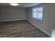 View of living room with vinyl floors, freshly painted walls, and a large window at 1835 E Atlanta Ave, Phoenix, AZ 85040