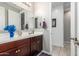 Bathroom with wood cabinets, a large mirror, and a light and bright interior at 19806 W San Miguel Ave, Litchfield Park, AZ 85340