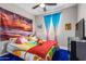 Brightly decorated bedroom featuring an array of color, a ceiling fan, and colorful wall decor at 19806 W San Miguel Ave, Litchfield Park, AZ 85340