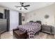 Stylish bedroom features a patterned comforter, ceiling fan, and contemporary decor at 19806 W San Miguel Ave, Litchfield Park, AZ 85340