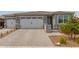 Inviting home featuring a three-car garage, complemented by a beautifully landscaped front yard at 19806 W San Miguel Ave, Litchfield Park, AZ 85340