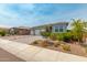 Beautiful single-Gathering home featuring a three-car garage and a well-manicured front lawn at 19806 W San Miguel Ave, Litchfield Park, AZ 85340