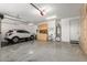 Spacious garage featuring a car, bicycle, and storage cabinets, providing ample space at 19806 W San Miguel Ave, Litchfield Park, AZ 85340