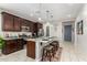 Kitchen featuring granite countertops, dark wood cabinets, stainless steel appliances, and pendant lighting at 19806 W San Miguel Ave, Litchfield Park, AZ 85340