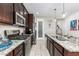 Gourmet kitchen featuring stainless steel appliances, dark cabinets, and sleek countertops at 19806 W San Miguel Ave, Litchfield Park, AZ 85340