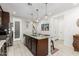 Island with granite countertops, pendant lights, and seating in an updated kitchen at 19806 W San Miguel Ave, Litchfield Park, AZ 85340