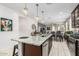 Open floorplan featuring kitchen island with granite countertops and stainless steel appliances at 19806 W San Miguel Ave, Litchfield Park, AZ 85340