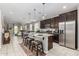 Open kitchen with stainless steel appliances, granite countertops, and seating at the kitchen island at 19806 W San Miguel Ave, Litchfield Park, AZ 85340