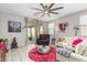 Airy living room with a large ceiling fan, modern decor, and light colored tile floors at 19806 W San Miguel Ave, Litchfield Park, AZ 85340