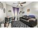 Living room featuring a ceiling fan, desk, sofa, shag rug, and a TV at 19806 W San Miguel Ave, Litchfield Park, AZ 85340