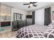 Beautifully decorated main bedroom featuring wood-look tile floors, ceiling fan, and matching dressers with a doorway to the bathroom at 19806 W San Miguel Ave, Litchfield Park, AZ 85340