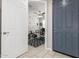 A view into the home office with a dark blue front door, a desk, and a geometric rug at 19806 W San Miguel Ave, Litchfield Park, AZ 85340