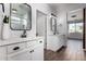 Bright bathroom features dual sinks with framed mirrors, tile flooring, and a step-in shower with glass door at 19982 W Glenrosa Ave, Litchfield Park, AZ 85340