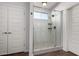 Shower showcases white wall tiles, a small window, and a patterned tile floor, offering a spa-like experience at 19982 W Glenrosa Ave, Litchfield Park, AZ 85340