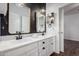 Stylish bathroom featuring dual sinks, modern fixtures, and decorative mirrors at 19982 W Glenrosa Ave, Litchfield Park, AZ 85340