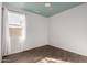 Well lit bedroom with neutral walls, wood-look floors, large window and light colored ceiling at 19982 W Glenrosa Ave, Litchfield Park, AZ 85340