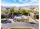 Stunning clubhouse entrance with palm trees, manicured landscaping, and a fountain at 19982 W Glenrosa Ave, Litchfield Park, AZ 85340