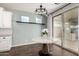 Cozy dining area with a marble table, sliding glass doors, and modern lighting at 19982 W Glenrosa Ave, Litchfield Park, AZ 85340