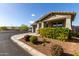 Charming single-story home with beautiful landscaping and a well-manicured lawn on a sunny day at 19982 W Glenrosa Ave, Litchfield Park, AZ 85340