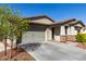 Attractive single-Gathering home showcasing a two-car garage, well-maintained landscaping, and inviting curb appeal at 19982 W Glenrosa Ave, Litchfield Park, AZ 85340