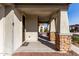 Welcoming covered front porch with stone accents offering a shaded entrance to the home at 19982 W Glenrosa Ave, Litchfield Park, AZ 85340