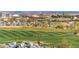 Expansive view of a well-manicured community golf course with homes in the background at 19982 W Glenrosa Ave, Litchfield Park, AZ 85340